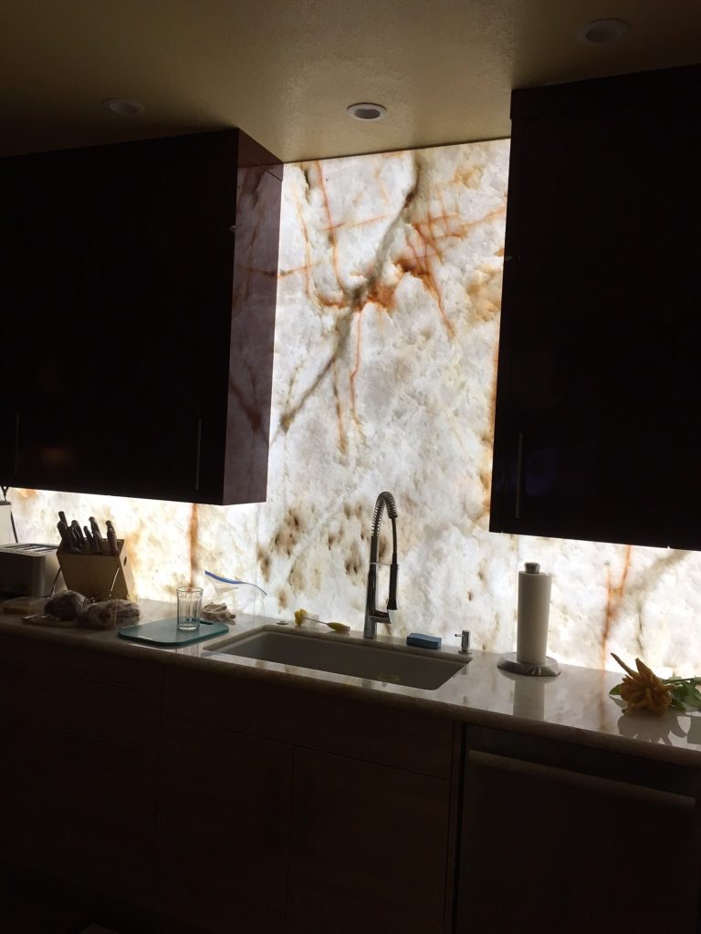 Kitchen countertop backlit with LED panels showcasing onyx stone