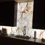 Cristallo Quartzite backsplash custom-cut and backlit behind LED panel