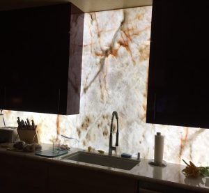 Cristallo Quartzite backsplash custom-cut and backlit behind LED panel