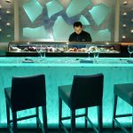 Stunning ThinkGlass countertop backlit with LED panels, highlighting its crystal-clear depth, smooth surface, and vibrant illuminated edges for a sleek, modern aesthetic