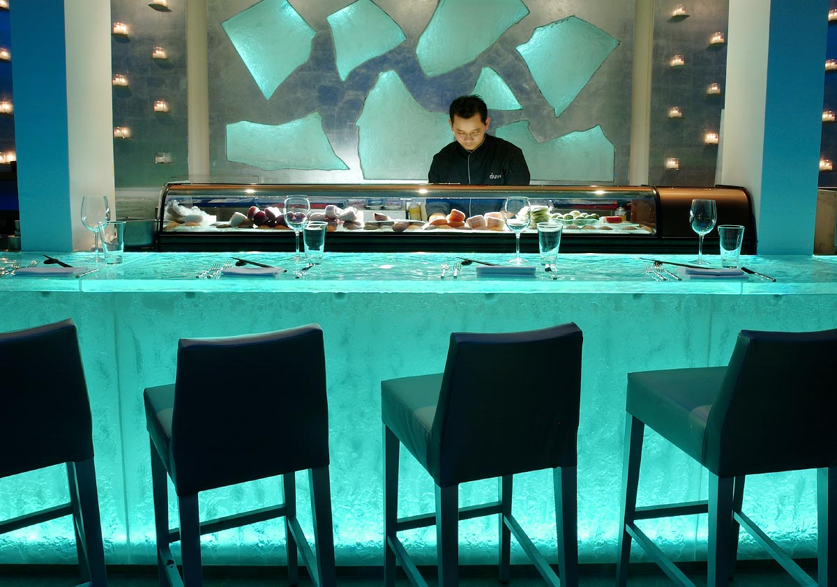Stunning ThinkGlass countertop backlit with LED panels, highlighting its crystal-clear depth, smooth surface, and vibrant illuminated edges for a sleek, modern aesthetic